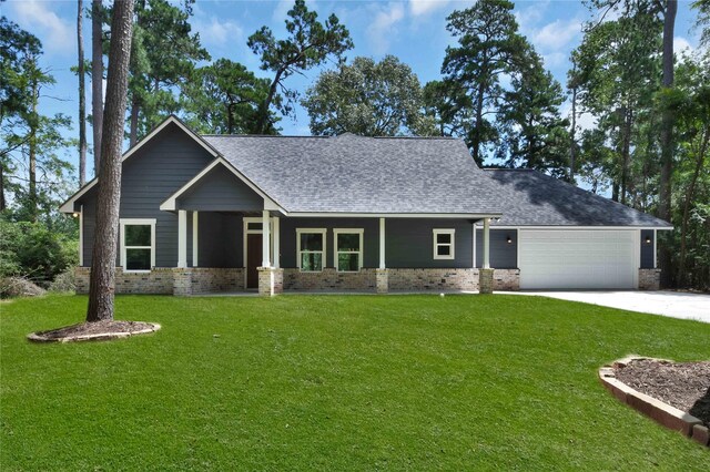 craftsman inspired home featuring a garage and a front lawn