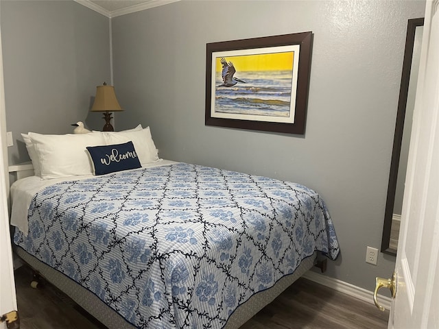 bedroom with crown molding and hardwood / wood-style floors