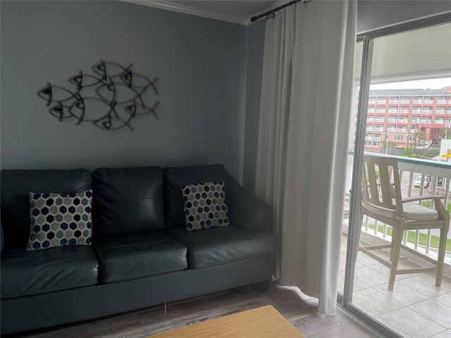 living room with crown molding and hardwood / wood-style flooring