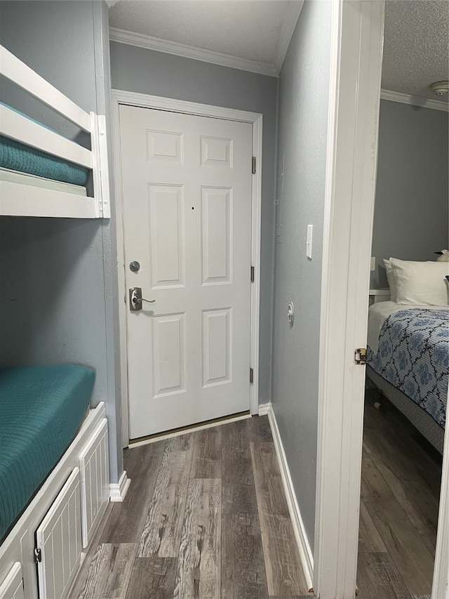 bedroom with ornamental molding, a closet, and dark wood-type flooring