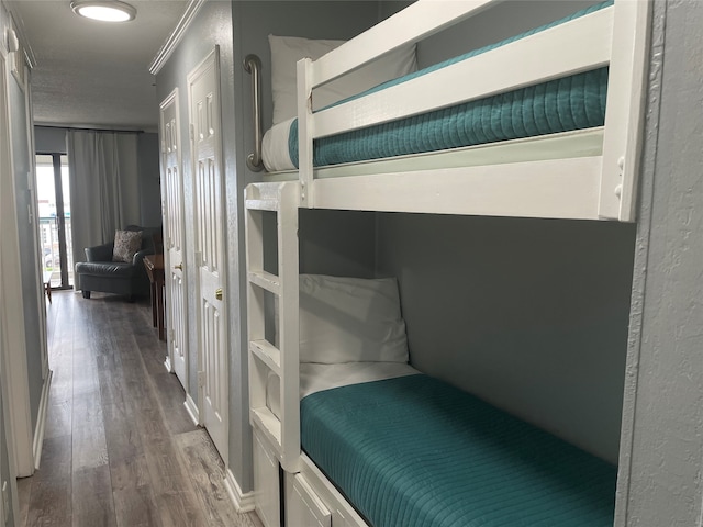 bedroom with hardwood / wood-style flooring and crown molding