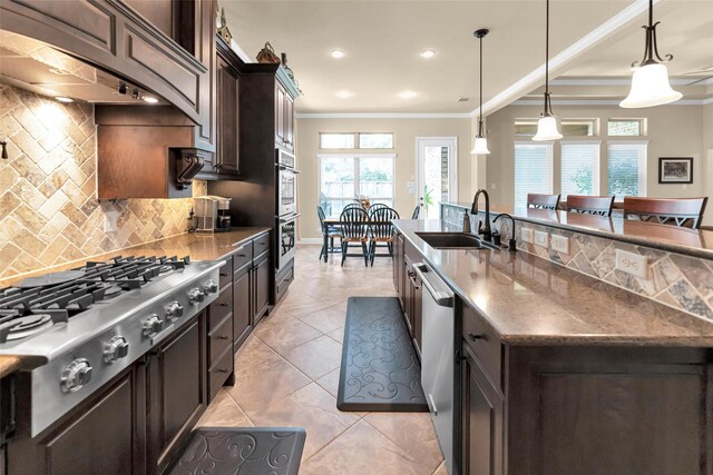 kitchen with pendant lighting, sink, crown molding, dark brown cabinets, and stainless steel appliances