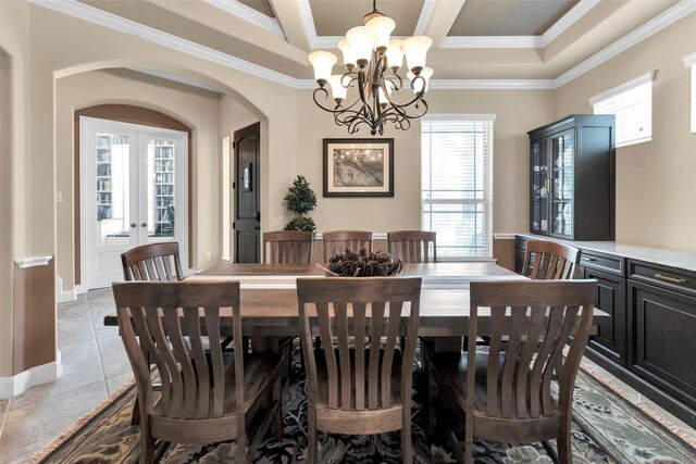 tiled dining area featuring ornamental molding, a notable chandelier, and french doors