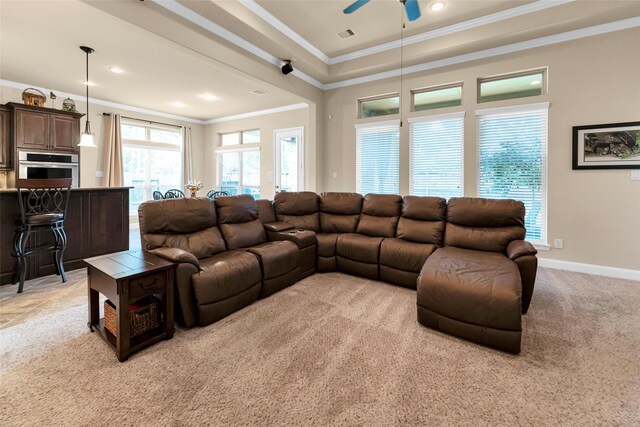 carpeted living room with crown molding, a raised ceiling, and ceiling fan