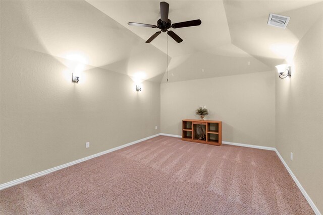 carpeted cinema room with ceiling fan and vaulted ceiling