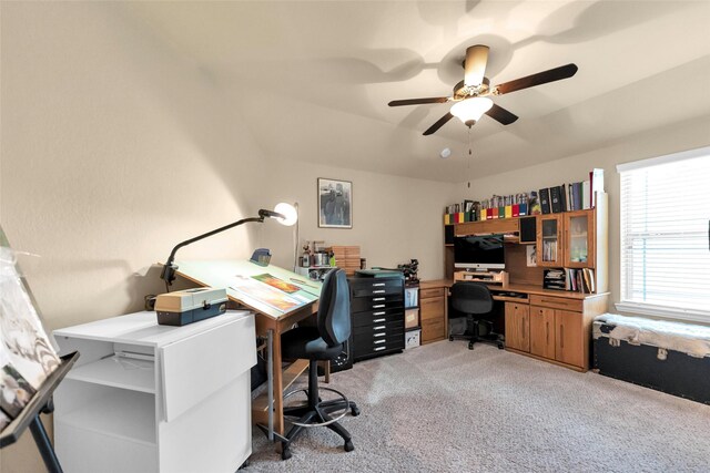 carpeted office featuring ceiling fan