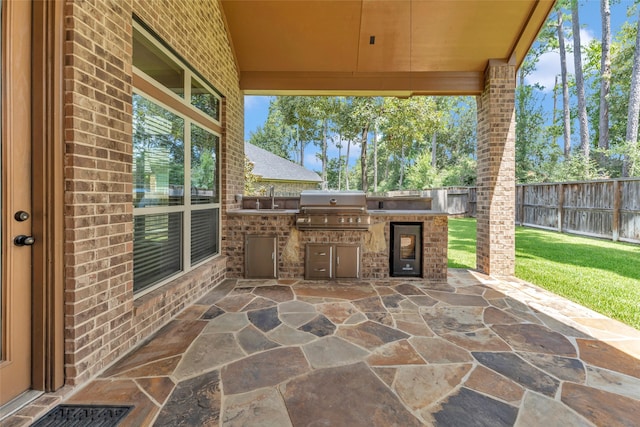 203 Gaillardia Ct, Pinehurst, TX 77362 - view of patio featuring grilling area, exterior kitchen, a sink, and wine cooler