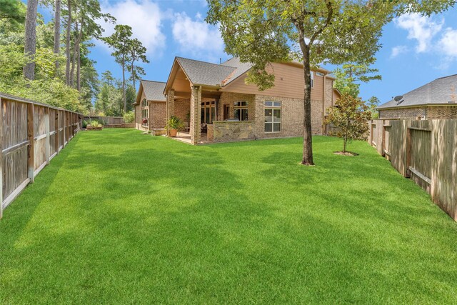 rear view of property featuring a lawn