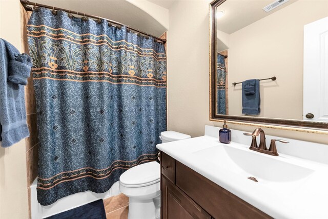 bathroom with vanity, a shower with shower curtain, and toilet