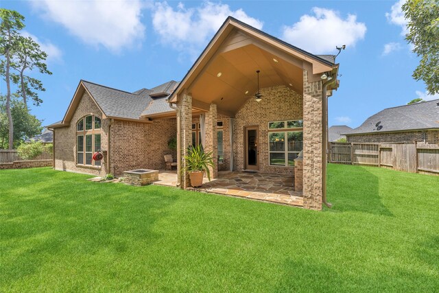 back of house featuring a patio area, ceiling fan, and a lawn