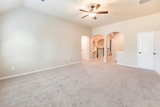 203 Gaillardia Ct, Pinehurst, TX 77362 - spare room with arched walkways, a ceiling fan, light carpet, baseboards, and lofted ceiling