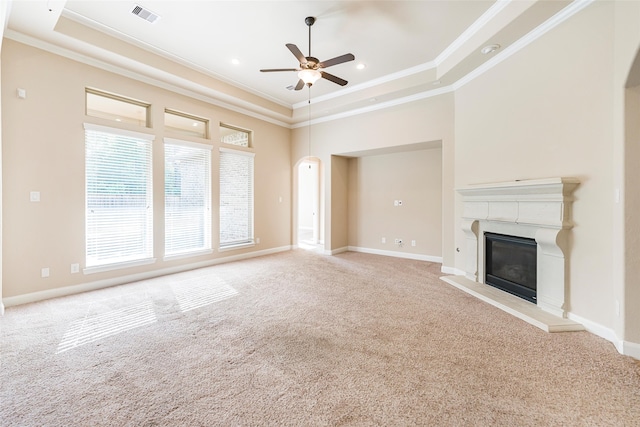 203 Gaillardia Ct, Pinehurst, TX 77362 - unfurnished living room featuring arched walkways, crown molding, a ceiling fan, and carpet floors