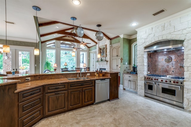 kitchen with appliances with stainless steel finishes, vaulted ceiling with beams, dark stone counters, and sink