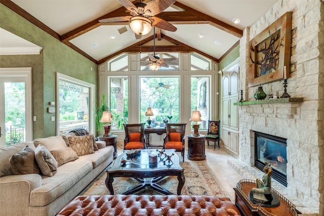 sunroom with vaulted ceiling with beams, ceiling fan, and a fireplace