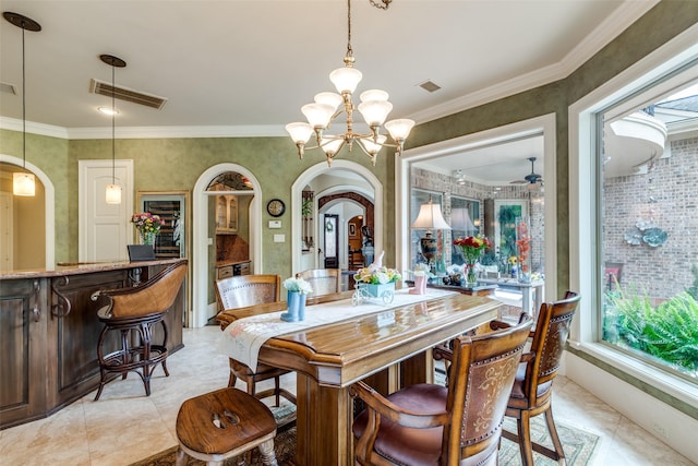 dining space with ceiling fan with notable chandelier and crown molding