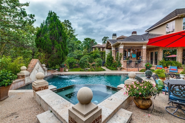 view of swimming pool featuring a patio area, an in ground hot tub, and french doors