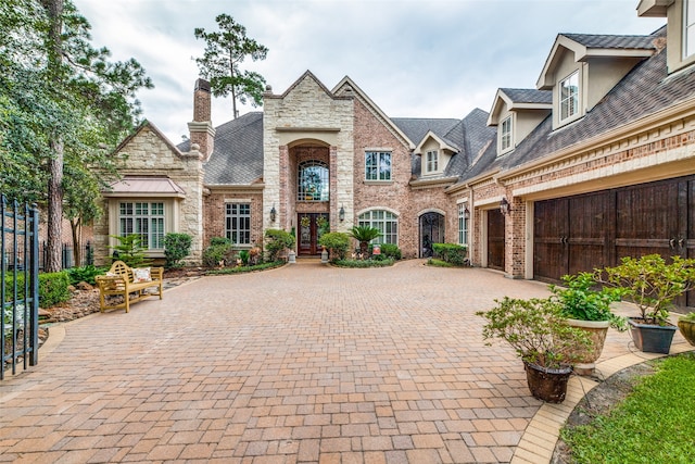 french country style house with a garage