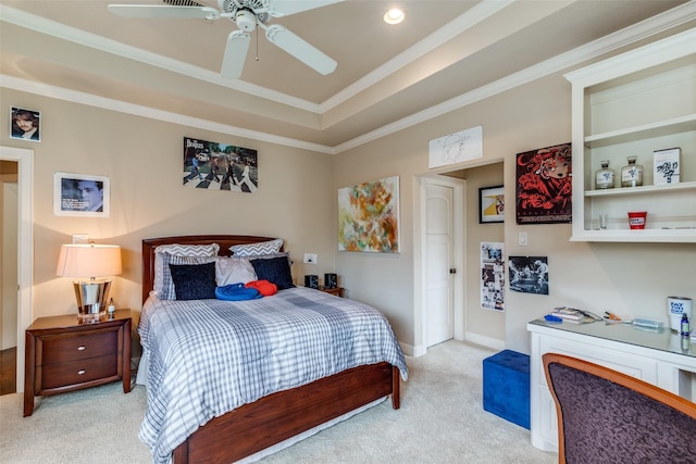 bedroom with light colored carpet, ceiling fan, crown molding, and a tray ceiling