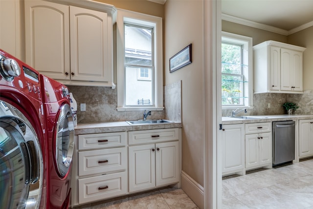 laundry area with crown molding, independent washer and dryer, and sink