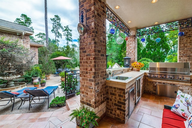 view of patio / terrace with area for grilling and sink