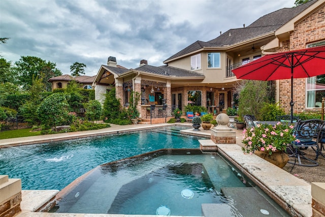 view of swimming pool with a patio area and an in ground hot tub