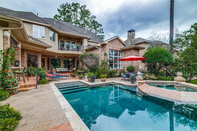 view of pool with a patio area, an outdoor hangout area, and an in ground hot tub