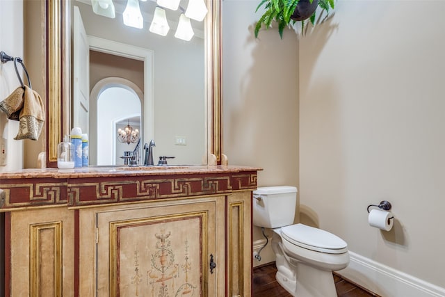 bathroom with hardwood / wood-style flooring, vanity, and toilet