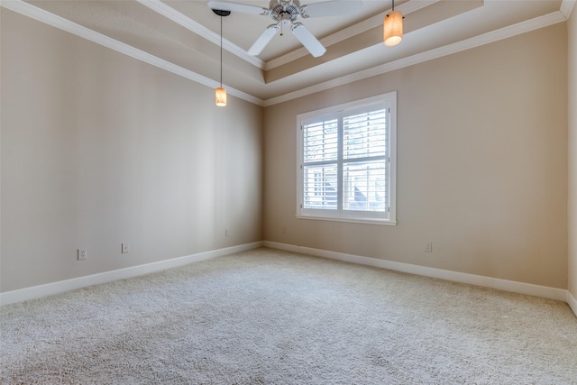 unfurnished room featuring carpet, ceiling fan, crown molding, and a tray ceiling