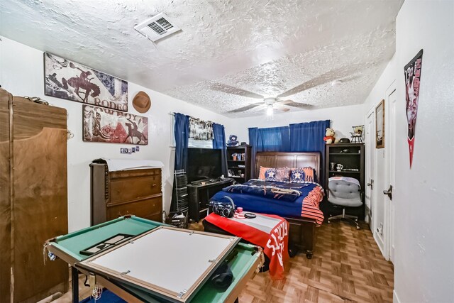 interior space with parquet floors, a textured ceiling, ceiling fan, and billiards