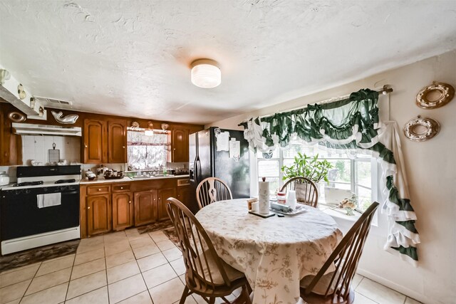 tiled dining area featuring sink