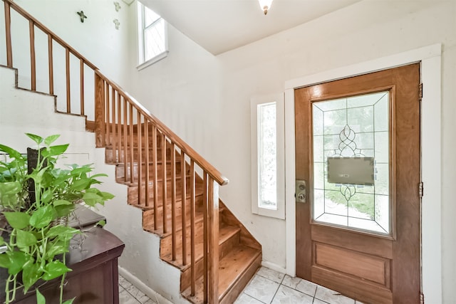 foyer entrance featuring a healthy amount of sunlight and light tile patterned floors