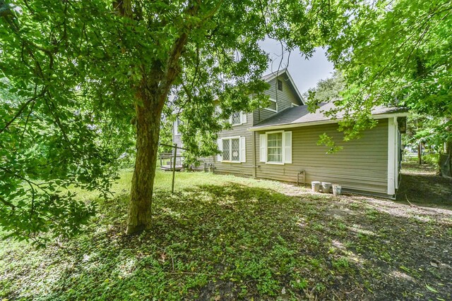 rear view of house with a yard