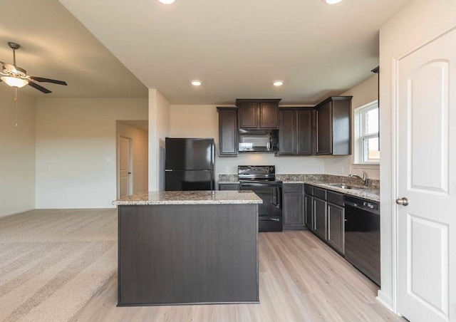 kitchen with light wood-type flooring, dark brown cabinets, black appliances, light stone countertops, and ceiling fan