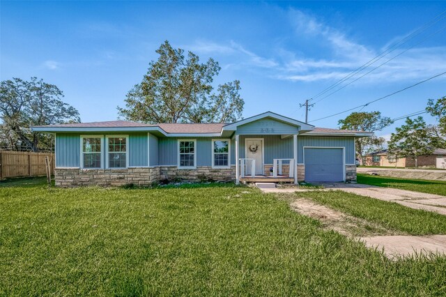 ranch-style home featuring a garage and a front yard