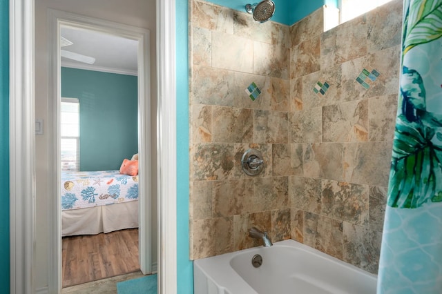 bathroom with crown molding, hardwood / wood-style floors, and shower / bathtub combination with curtain