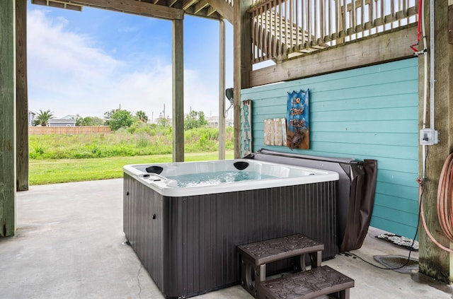 view of patio / terrace with cooling unit and a hot tub