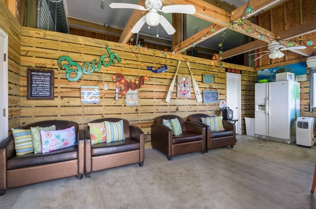 living room featuring hardwood / wood-style floors, wooden walls, and ceiling fan