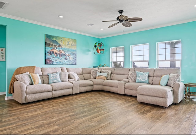 living room featuring hardwood / wood-style flooring, crown molding, and ceiling fan