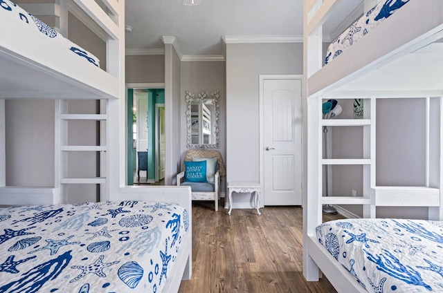 bedroom featuring dark wood-type flooring and crown molding