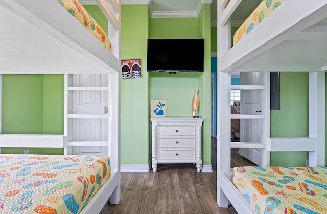 bedroom with dark hardwood / wood-style flooring and ornamental molding