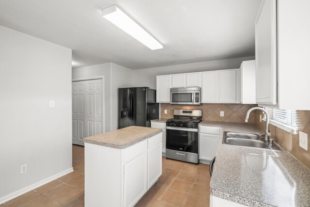 kitchen with light tile patterned floors, stainless steel appliances, tasteful backsplash, and sink