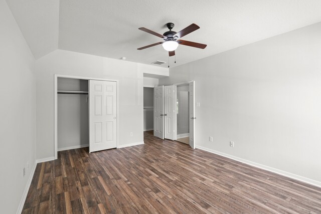 unfurnished bedroom featuring wood-type flooring, vaulted ceiling, a closet, and ceiling fan