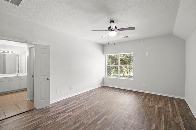 interior space with a textured ceiling, vaulted ceiling, and ceiling fan