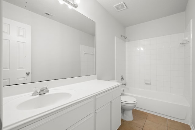 full bathroom featuring tile patterned flooring, tiled shower / bath combo, toilet, and vanity