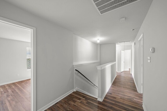 corridor with wood-type flooring