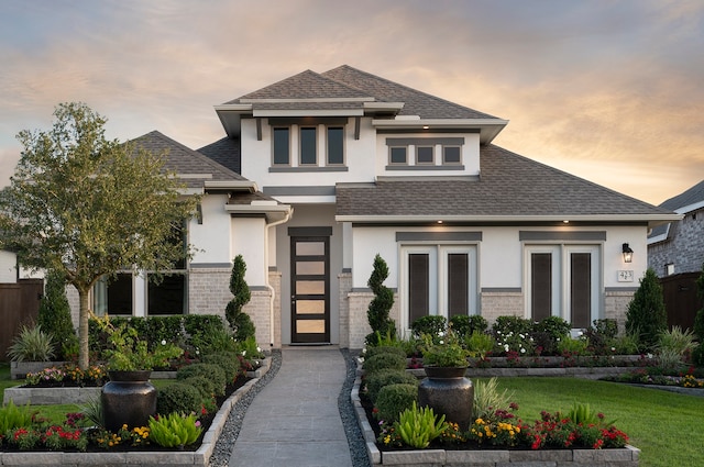 prairie-style home featuring a yard