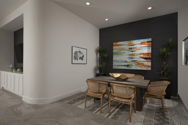 dining room with wooden walls