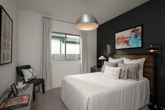 bedroom featuring wood walls and carpet