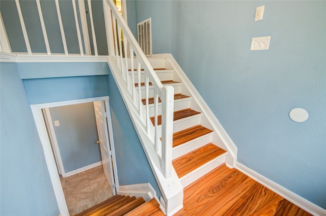 stairway featuring tile patterned flooring