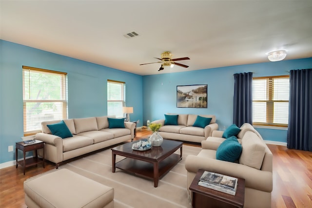 living room with ceiling fan and light hardwood / wood-style flooring